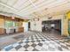 Large garage space featuring checkered tile, storage, and multiple entrances at 4733 E 100 S, Anderson, IN 46017