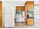 Bright kitchen showcasing a refrigerator, built-in oven, and wood cabinets at 4733 E 100 S, Anderson, IN 46017