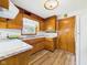 Cozy kitchen with wood cabinets, laminate countertops, and a double-basin sink at 4733 E 100 S, Anderson, IN 46017