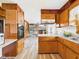 Kitchen area featuring wood cabinetry, laminate countertops, and modern appliances at 4733 E 100 S, Anderson, IN 46017