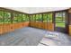 Relaxing sunroom with multiple windows, wood paneling, and carpet flooring at 4733 E 100 S, Anderson, IN 46017