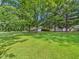 Expansive green lawn with large trees surrounding the property at 4733 E 100 S, Anderson, IN 46017