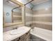 Bathroom with a vanity, large mirror, and shower-tub combination at 5050 W Regent St, Indianapolis, IN 46241