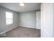 This is a bedroom with gray walls, carpeted floors, and a bright window at 5050 W Regent St, Indianapolis, IN 46241