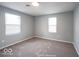 A clean and neutral bedroom with two windows and carpeted floor at 5050 W Regent St, Indianapolis, IN 46241