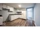 Functional kitchen with white cabinets, laminate countertops, and vinyl flooring at 5050 W Regent St, Indianapolis, IN 46241