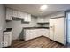 Practical kitchen with white cabinets, laminate countertops, and wood-look vinyl flooring at 5050 W Regent St, Indianapolis, IN 46241