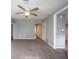 Spacious living room featuring neutral paint, modern fan, and an open layout at 5050 W Regent St, Indianapolis, IN 46241