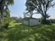 There are two detached garages in a backyard setting surrounded by healthy lawn at 5159 E Edgewood Ave, Indianapolis, IN 46237