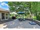 Stone patio features an umbrella table set with room for outdoor entertaining and dining at 5215 Limestone Ct, Indianapolis, IN 46237