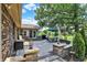 Outdoor patio area features brick and stone pavers, dining set with umbrella, and mature landscaping at 5215 Limestone Ct, Indianapolis, IN 46237