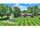 Expansive backyard featuring a well-kept lawn and mature trees providing ample shade and privacy at 5215 Limestone Ct, Indianapolis, IN 46237