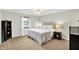 Cozy bedroom featuring a beige upholstered headboard, neutral walls and ceiling fan at 5215 Limestone Ct, Indianapolis, IN 46237