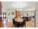 Charming dining area features a wood table, decorative hutch, and hardwood floors, adjacent to the kitchen at 5215 Limestone Ct, Indianapolis, IN 46237