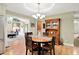 Inviting dining room showcasing a wood table, traditional hutch, and hardwood flooring next to living area at 5215 Limestone Ct, Indianapolis, IN 46237