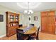 Cozy dining area highlighting a wooden table, classic hutch, and hardwood floors adjacent to kitchen storage at 5215 Limestone Ct, Indianapolis, IN 46237