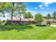 Charming single story brick home with lush front lawn and mature landscaping at 5215 Limestone Ct, Indianapolis, IN 46237