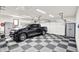 Bright garage showcases a black truck, ample storage cabinets, and a black and gray checkerboard floor at 5215 Limestone Ct, Indianapolis, IN 46237