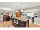 Spacious kitchen featuring a large island with seating, stainless steel appliances, and access to living spaces at 5215 Limestone Ct, Indianapolis, IN 46237