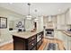 Well-appointed kitchen with an island, stainless steel appliances, and white cabinetry, open to living room at 5215 Limestone Ct, Indianapolis, IN 46237