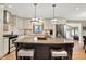 Well-equipped kitchen offering an island, stainless appliances, granite counters, and pristine white cabinets at 5215 Limestone Ct, Indianapolis, IN 46237