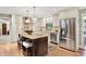 Modern kitchen featuring a center island, stainless steel appliances, white cabinetry, and granite countertops at 5215 Limestone Ct, Indianapolis, IN 46237