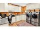 Functional laundry room with built-in cabinets and modern appliances at 5215 Limestone Ct, Indianapolis, IN 46237