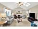 Cozy living room with vaulted ceilings, skylights, and a stone fireplace at 5215 Limestone Ct, Indianapolis, IN 46237