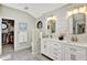 The primary bath includes double sinks, white cabinets, wood-look accent wall, and an octagon window at 5215 Limestone Ct, Indianapolis, IN 46237