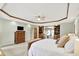 An expansive primary bedroom is equipped with a ceiling fan, built-in shelving, and a bay window at 5215 Limestone Ct, Indianapolis, IN 46237