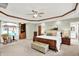 A beautifully appointed primary bedroom features neutral carpeting and a sitting area with a bay window at 5215 Limestone Ct, Indianapolis, IN 46237