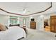 A spacious primary bedroom with neutral carpet has room for a chest of drawers and a sitting area at 5215 Limestone Ct, Indianapolis, IN 46237