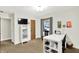 Craft room featuring a white desk, organized storage and a wall-mounted TV at 5215 Limestone Ct, Indianapolis, IN 46237