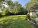 Lush green backyard with a shade trees providing a serene outdoor space, complete with a charming pergola at 526 Emerson Rd, Carmel, IN 46032