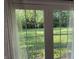 French doors showcasing the serene backyard and lush greenery create an inviting indoor-outdoor flow at 526 Emerson Rd, Carmel, IN 46032