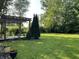 Serene backyard featuring lush greenery, a pergola, and a peaceful setting at 526 Emerson Rd, Carmel, IN 46032