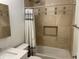 Bathroom showcasing the shower-over-tub and neutral colored tiling at 526 Emerson Rd, Carmel, IN 46032