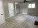 Large carpeted bedroom featuring a ceiling fan and walk-in closet with mirror doors at 526 Emerson Rd, Carmel, IN 46032