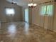 Open-concept living room features neutral tile flooring, modern ceiling fan, and plenty of natural light at 526 Emerson Rd, Carmel, IN 46032