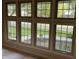 Bright room with multiple windows offering a view of the landscaped yard and neighborhood street at 526 Emerson Rd, Carmel, IN 46032