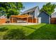 Lush backyard with a pergola-covered patio, well-manicured lawn, and privacy fencing at 608 E 9Th St, Indianapolis, IN 46202