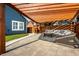 Inviting backyard patio with a wood pergola, stone pavers, and comfortable outdoor seating area at 608 E 9Th St, Indianapolis, IN 46202
