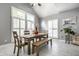 Bright dining area featuring a wooden table set, large windows, and vaulted ceilings at 608 E 9Th St, Indianapolis, IN 46202