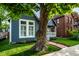 Charming blue home exterior with a brick walkway leading to a welcoming front porch and yard at 608 E 9Th St, Indianapolis, IN 46202