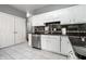 Well-organized kitchen featuring white cabinets, stainless steel appliances, and tile flooring at 608 E 9Th St, Indianapolis, IN 46202