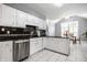 Bright kitchen features white cabinets, black countertops and stainless steel appliances at 608 E 9Th St, Indianapolis, IN 46202