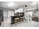 Well-lit kitchen area with a marble-top breakfast bar, white cabinetry, and tile floors at 608 E 9Th St, Indianapolis, IN 46202