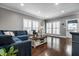 Spacious living room with hardwood floors, large windows, and a comfortable blue sectional sofa at 608 E 9Th St, Indianapolis, IN 46202