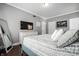 Large main bedroom with hardwood floors, a TV and a modern color scheme at 608 E 9Th St, Indianapolis, IN 46202