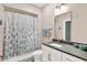 Bathroom with a white vanity, a shower with a decorative floral curtain, and stylish fixtures at 622 E 10Th St # 310, Indianapolis, IN 46202